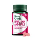 Nature's Own Hair, Skin and Nails dietary supplement bottle with a dark green cap and a pink and white label, shown on a white background with two pink tablets in front.