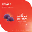 Dosage instructions for children with two purple pastilles on a red background