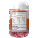 A clear plastic bottle of pink gummies with a white cap, showing the back of the label with serving suggestions and nutrition information. The gummies inside are visible through the transparent bottle.