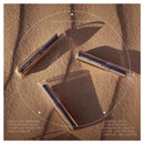Three lip products on a sandy surface with text overlay.