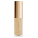 Cosmetic bottle with gold cap and beige body on a white background