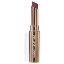 Lipstick with rose gold casing and 'Nude by Nature' branding on a white background