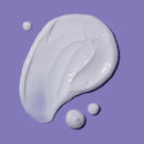 White cream or lotion with droplets on a purple background