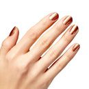 Hand with rose gold nail polish on a white background
