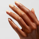 Close-up of a hand with beige nail polish on a light gray background