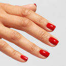 Hand with red nail polish on a light gray background