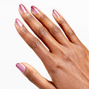 Hand with pink nail polish on a white background