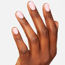 Hand with light pink nail polish on a white background