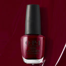 OPI nail polish bottle with black cap on a red background