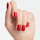 Hand with red nail polish on a light gray background