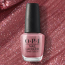 OPI nail polish bottle on a glittery pink background