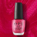OPI nail polish bottle on a pink glittery background