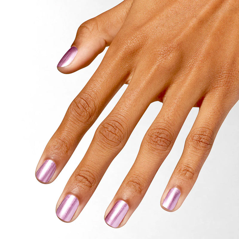 Hand with pink metallic nail polish on a white background