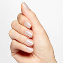 Hand with light pink nail polish on a plain background