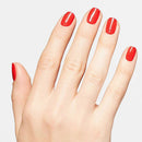 Hand with red nail polish on a light gray background