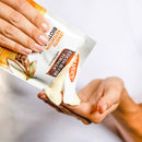 Person holding Palmer's cocoa butter bar with a white background