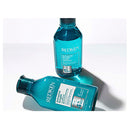 Two Redken bottles on a white background