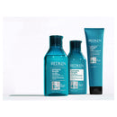 Redken hair care products including shampoo and conditioner on a white background