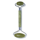 Revlon facial roller with green stones on a white background