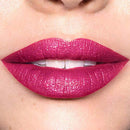 Close-up of a person wearing bright pink lipstick on a neutral background