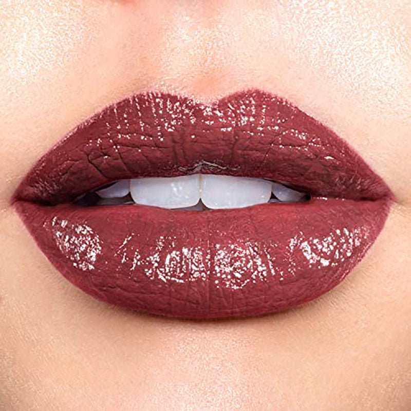 Close-up of a person wearing a glossy burgundy lipstick.