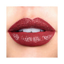 Close-up of a person wearing a glossy red lipstick on a white background