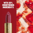 Lipstick with red lipstick and oil droplets on a red background, featuring text about conditioning ingredients.