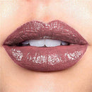 Close-up of a person's lips with a glossy, mauve lipstick.