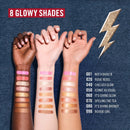 Three hands with makeup swatches on a denim background, featuring 8 glowing shades.