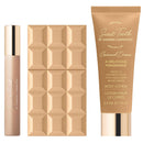 Three Sabrina Carpenter Sweet Tooth Caramel Dream body lotion items arranged on a white background: a small cylindrical bottle, a square box with a 3D geometric pattern, and a larger squeeze tube.