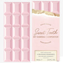 Pink perfume bottle with geometric design and 'Sweet Tooth by Sabrina Carpenter' packaging.