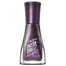 Sally Hansen Insta-Dri Galactic nail polish in a clear glass bottle with a metallic purple cap, showing a sparkly iridescent purple and green holographic polish inside.
