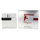 A bottle of Salvatore Ferragamo Pour Homme Eau de Toilette spray next to its silver packaging box with a red logo.
