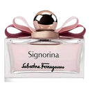 Signorina by Salvatore Ferragamo perfume bottle with a pale pink liquid, a metallic rose gold cap, and a pink ribbon bow on a white background.