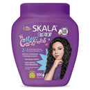 Purple Skala hair care product container with a woman's face on the label