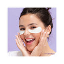 Woman applying eye patches with a purple background, featuring 'Skin Republic' branding.