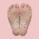 Feet with lacey transparent socks on a pink background