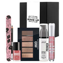 The Ultimate Make Up Kit Nudes Edition cosmetic gift set with MUD nude eyeshadow palette, black kajal eyeliner, nail polish, pink nail file, Essence lip gloss, and Ulta3 primer, displayed on a white background.