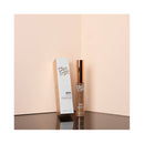 Eyebrow product with packaging on a reflective surface and light pink background