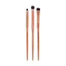 Three makeup brushes with wooden handles on a white background