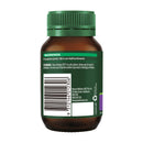 Back view of a brown amber supplement bottle with a dark green cap and a dark green label featuring a barcode and product warnings.