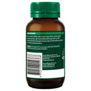 Back view of an amber brown supplement bottle with a green cap, showing the printed warning label and barcode on a white background.
