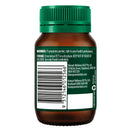 Back view of a brown supplement bottle with green cap on a white background