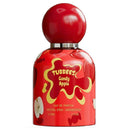 Tubbees Candy Apple Eau de Parfum bottle, featuring a glossy red design with yellow splatter graphics, apple illustrations, and a matching red spherical cap on a white background.