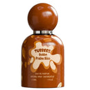 A 50ml bottle of Tubbees Golden Praline Bliss Eau de Parfum, styled like a chocolate-covered stick figure with a glossy brown spherical cap, on a solid white background.