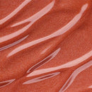 Textured fabric with abstract leaf pattern in pink on a red-brown background