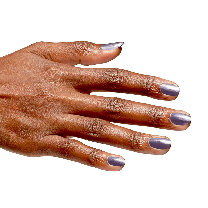 Hand with purple nail polish on a white background