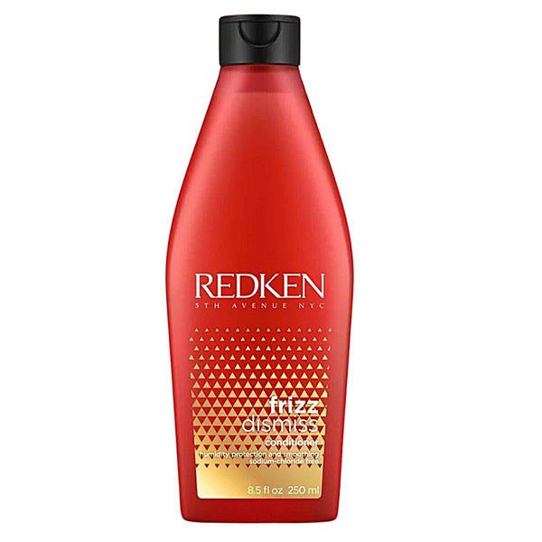 Redken bottle of frizz dismiss shampoo on a white background